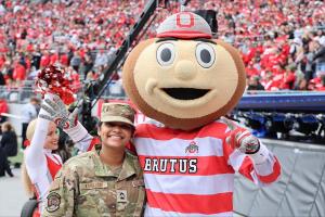 Brutus Buckeye stands with an ROTC cadet at a Buckeyes football game